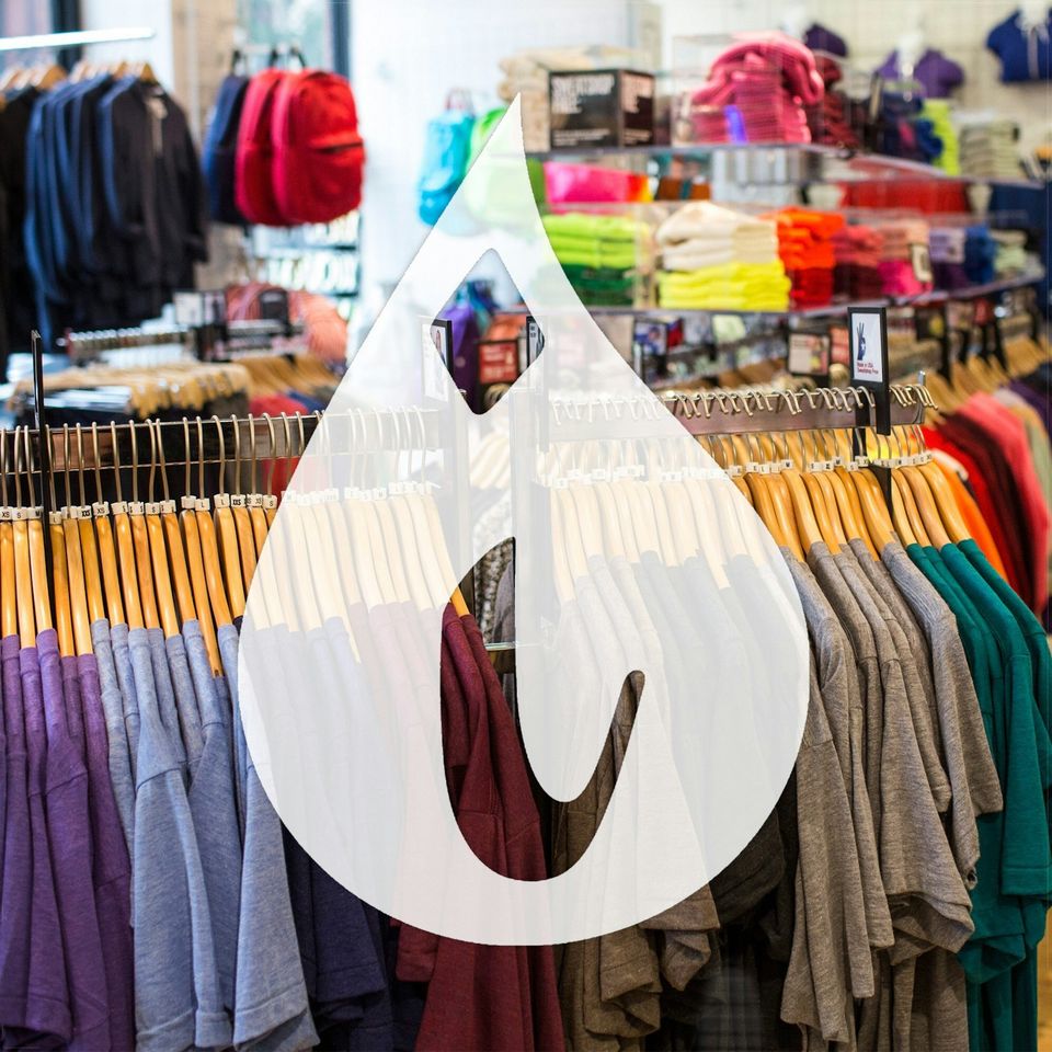 Clothing racks at Inkable Clothing, with the ink-drop mark over the shop
